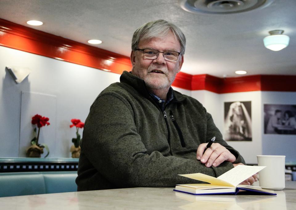 Former Enquirer reporter Howard Wilkinson sits at the counter at Hathaway's former location inside Carew Tower.