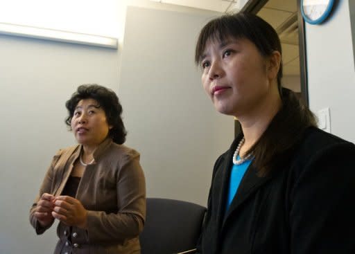 Ma Chunmei (R) and Wang Chunying are interviewed at the AFP offices in Washington, DC, on April 30, 2013. The women described their detention and torture at a Chinese labor camp for refusing to denounce Falun Gong