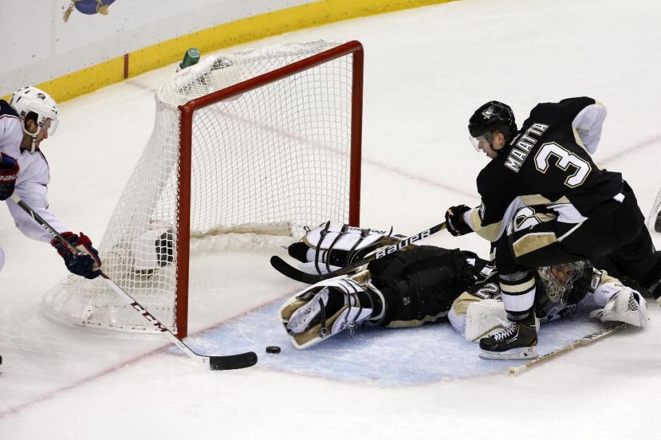 Columbus Blue Jackets' Boone Jenner, left, prepares to put the puck into the net for a goal behind Pittsburgh Penguins goalie Marc-Andre Fleury and Olli Maatta (3) in the first period of Game 5 of a first-round NHL playoff hockey series in Pittsburgh, Saturday, April 26, 2014. (AP Photo/Gene J. Puskar)