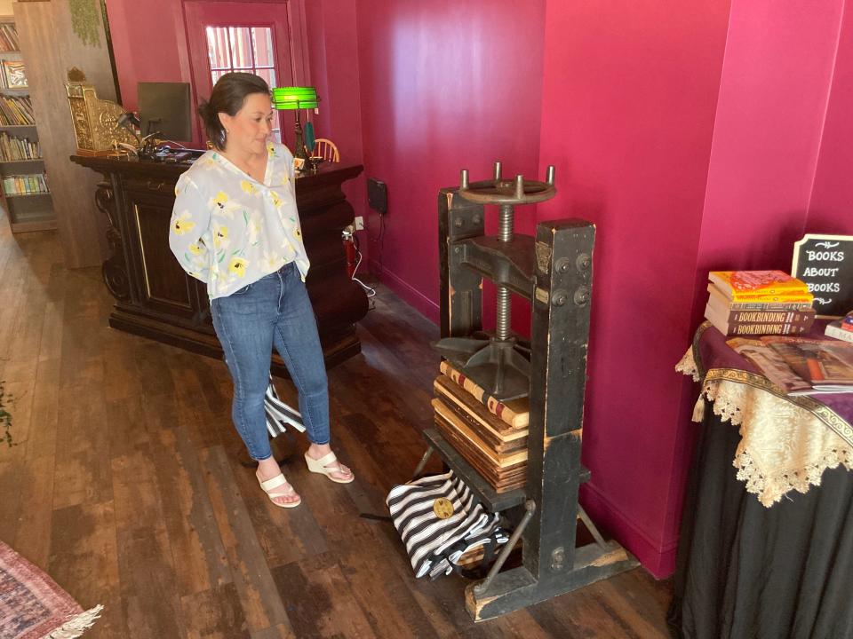 "I thought if I can offer this without losing focus on books, it should be good," said Elaine Powers. She stands next to an old book press manufactured in Pennsylvania and had been in use in a bookbinding business in Philadelphia. It still works.