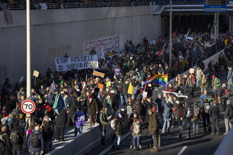 Extinction Rebellion activists and sympathisers block a busy road in The Hague, Netherlands, Saturday, Jan. 28, 2023. Earlier this week seven Extinction Rebellion activists were detained by authorities for sedition linked to the protest. (AP Photo/Peter Dejong)