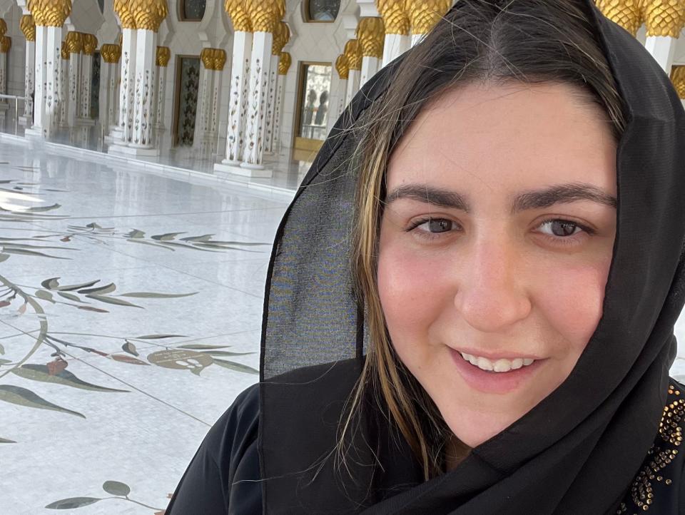 The writer wears a traditional abaya at the Sheikh Zayed Grand Mosque.