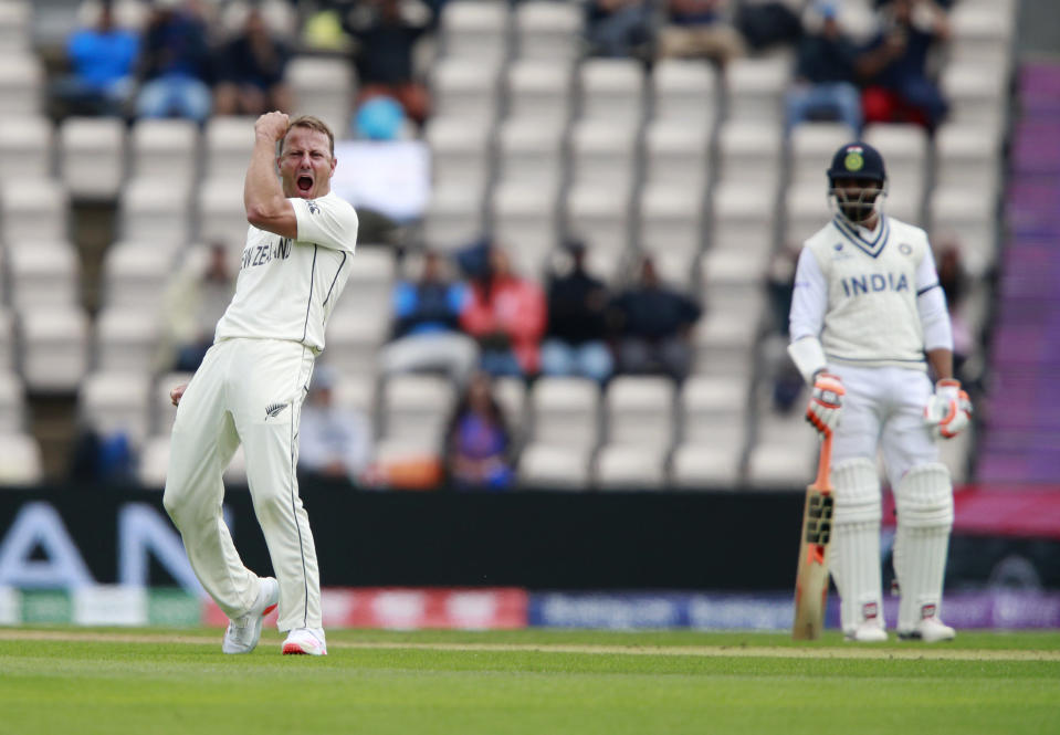 New Zealand's Neil Wagner, left, celebrates the dismissal of India's Ajinkya Rahane during the third day of the World Test Championship final cricket match between New Zealand and India, at the Rose Bowl in Southampton, England, Sunday, June 20, 2021. (AP Photo/Ian Walton)