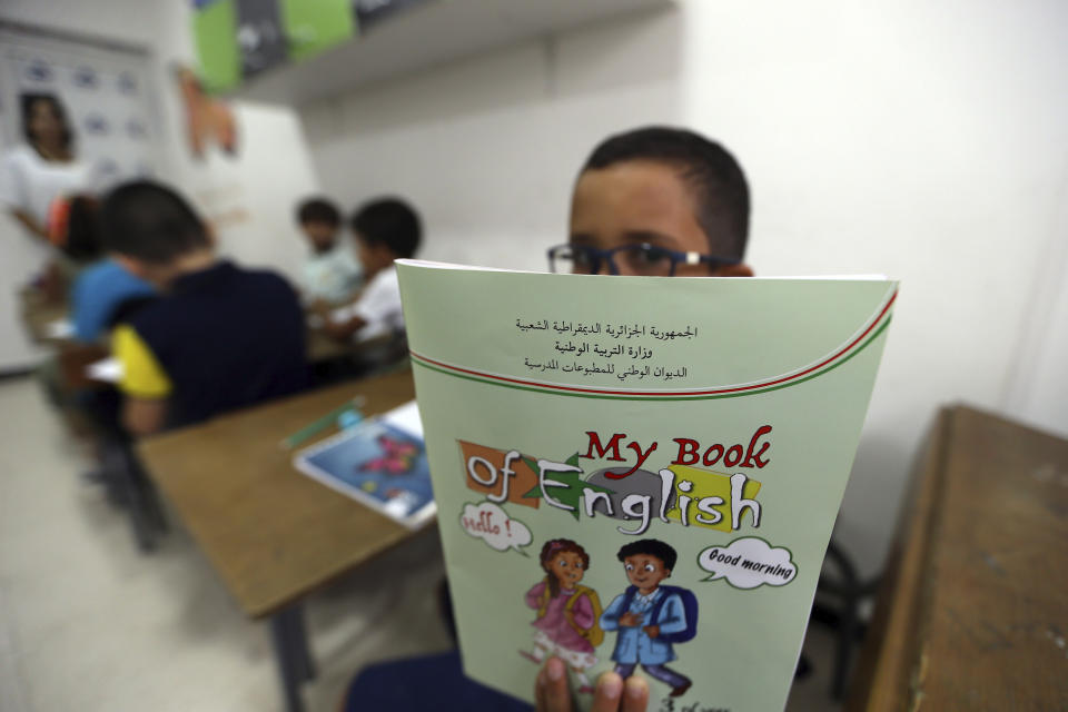 Schoolchild shows his English lessons book in a private school of Birkhadem, outside Algiers, Wednesday, Sept.21, 2022. Algerian children went back to school Wednesday Sept. 21, 2022 for the first time since the president last month ordered schools to switch from teaching French as a second language alongside Arabic to English instead. The government says the move is a modernization effort but it is also seen as a way for Algeria to distance itself from its past as a French colony. (AP Photo/Fateh Guidoum)