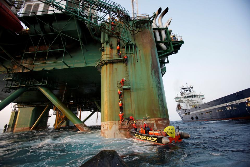 'GPAction' by Steve Morgan, snapped 180km off the coast of Greenland. A group of international Greenpeace activists climb onto the oil rig with the hope of stopping the drilling in Baffin Bay which is a fragile home to vulnerable wildlife including polar bears and sea whales (Steve Morgan)