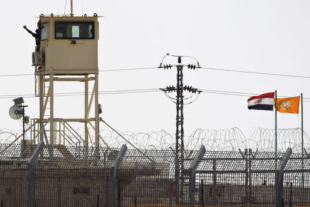 A member of Egypt's security forces gestures as he stands on a watchtower in North Sinai as seen from across the border in southern Israel July 2, 2015. REUTERS/Amir Cohen