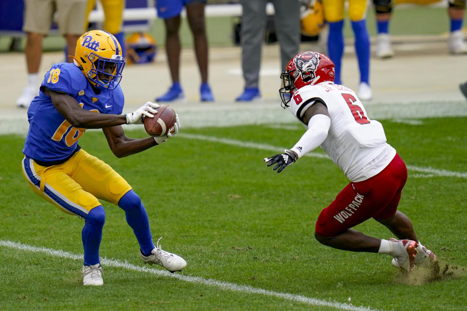 Pittsburgh Panthers wide receiver Shocky Jacques-Louis (18) makes a catch in front of North Carolina State safety Jakeen Harris (6) in the first half of an NCAA college football game, Saturday, Oct. 3, 2020, in Pittsburgh. (AP Photo/Keith Srakocic)