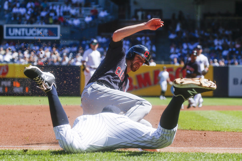 Cleveland Indians' Bradley Zimmer, right, dives safely into third base as New York Yankees' DJ LeMahieu tries to tag him out in the first inning of a baseball game, Sunday, Sept. 19, 2021, in New York. (AP Photo/Eduardo Munoz Alvarez)