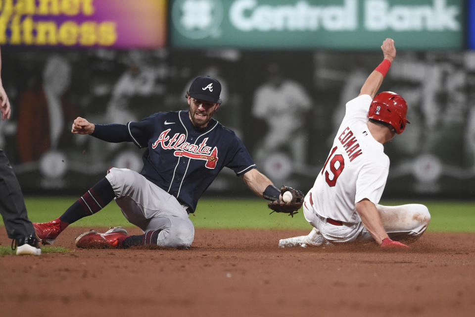 St. Louis Cardinals' Tommy Edman (19) safely steals second base ahead of a tag from Atlanta Braves shortstop Dansby Swanson (7) in the third inning of a baseball game against on Friday, Aug. 26, 2022, in St. Louis. (AP Photo/Joe Puetz)