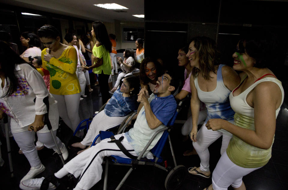 In this Dec. 4, 2018 photos, dancers pose for a group photo prior to their performance in the contemporary dance production Ubuntu, at the Teresa Carreno Theater in Caracas, Venezuela. "Dancing is all about passion" said AM Danza's director. "You have to enjoy your possibilities and use your body to express emotions." (AP Photo/Fernando Llano)