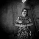 <p>Healer Josefina Vazquez de Gonzalez holds her sacred bone for healing. The bone must always be covered and cannot be revealed to anyone. (Photograph by Fran Antmann) </p>