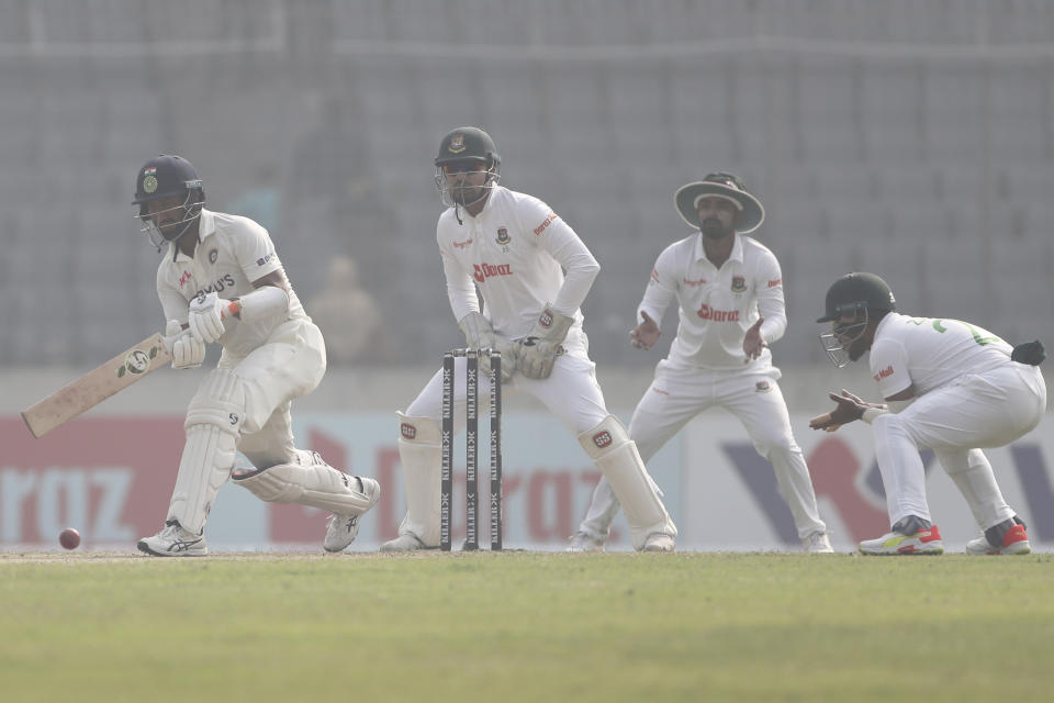 India's Cheteshwar Pujara, left, plays a shot on the day two of the second test cricket match Bangladesh between India, in Dhaka, Bangladesh, Friday, Dec. 23, 2022. (AP Photo/Surjeet Yadav)