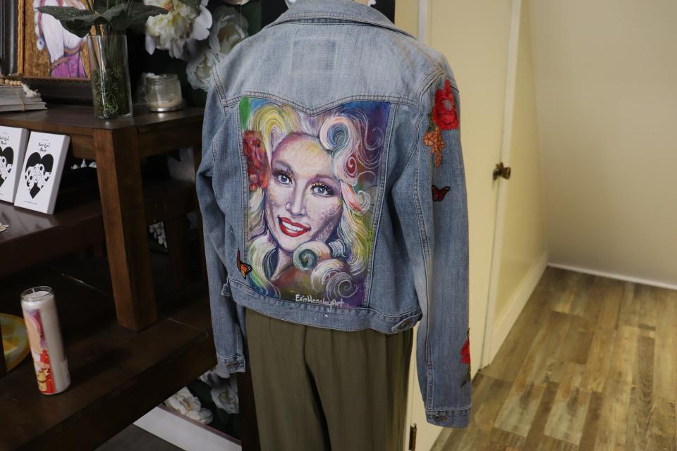 A denim jacket with Dolly Parton's face painted on the back sold at Jolene's boutique.