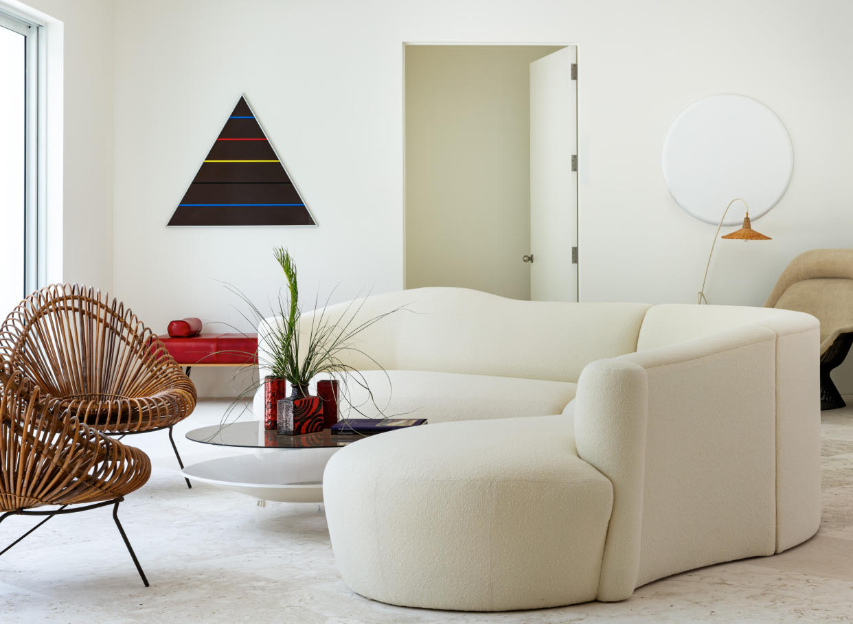  A curved white sofa in a living room 