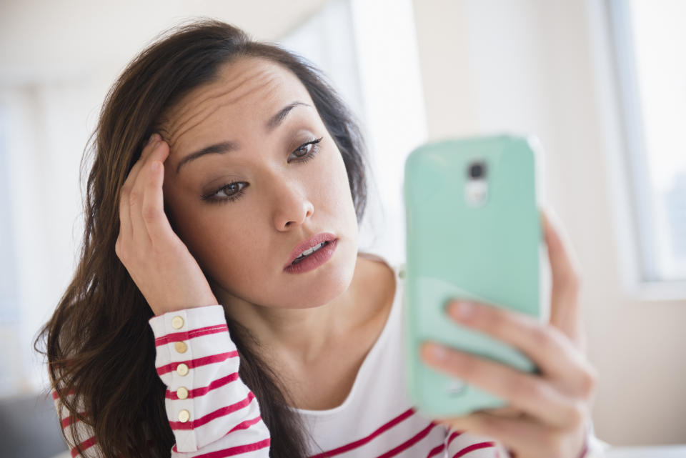 Stressed woman using mobile phone.