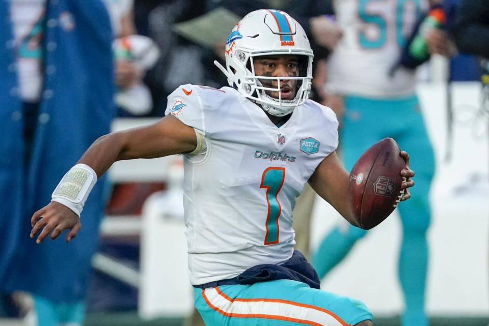 Miami Dolphins quarterback Tua Tagovailoa (1) runs against the Denver Broncos.