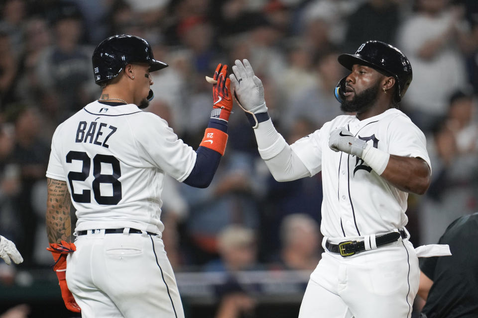 Detroit Tigers' Javier Baez (28) and Akil Baddoo celebrate scoring against the Cleveland Guardians in the fourth inning of a baseball game, Friday, Sept. 29, 2023, in Detroit. (AP Photo/Paul Sancya)