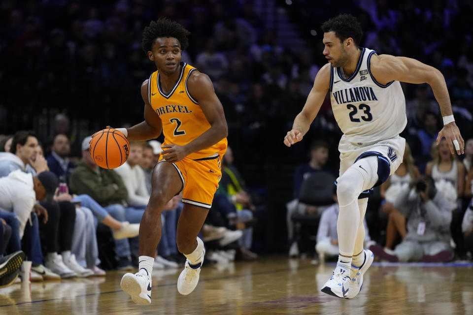 Drexel's Lucas Monroe, left, tries to get past Villanova's Tyler Burton during the second half of an NCAA college basketball game, Saturday, Dec. 2, 2023, in Philadelphia. (AP Photo/Matt Rourke)