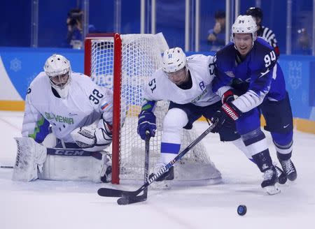 REFILE - CORRECTING SLUG Ice Hockey – Pyeongchang 2018 Winter Olympics – Men Preliminary Round Match - U.S. v Slovenia - Kwandong Hockey Centre, Gangneung, South Korea – February 14, 2018 - Ryan Stoa (R) of the U.S. in action with Mitja Robar of Slovenia. REUTERS/Brian Snyder