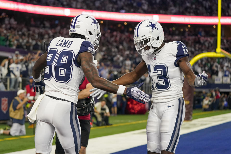Dallas Cowboys wide receiver CeeDee Lamb (88) celebrates his first half touchdown with wide receiver Michael Gallup (13) during an NFL football game against the Philadelphia Eagles, Sunday, Dec. 10, 2023, in Arlington, Texas. (AP Photo/Sam Hodde)