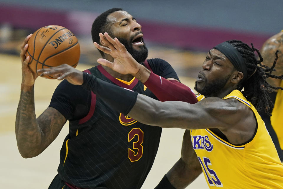 Cleveland Cavaliers' Andre Drummond (3) drives past Los Angeles Lakers' Montrezl Harrell (15) in the first half of an NBA basketball game, Monday, Jan. 25, 2021, in Cleveland. (AP Photo/Tony Dejak)