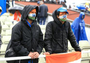 Indian fans shelter from the rain during the ICC Champions Trophy Final at Edgbaston, Birmingham.