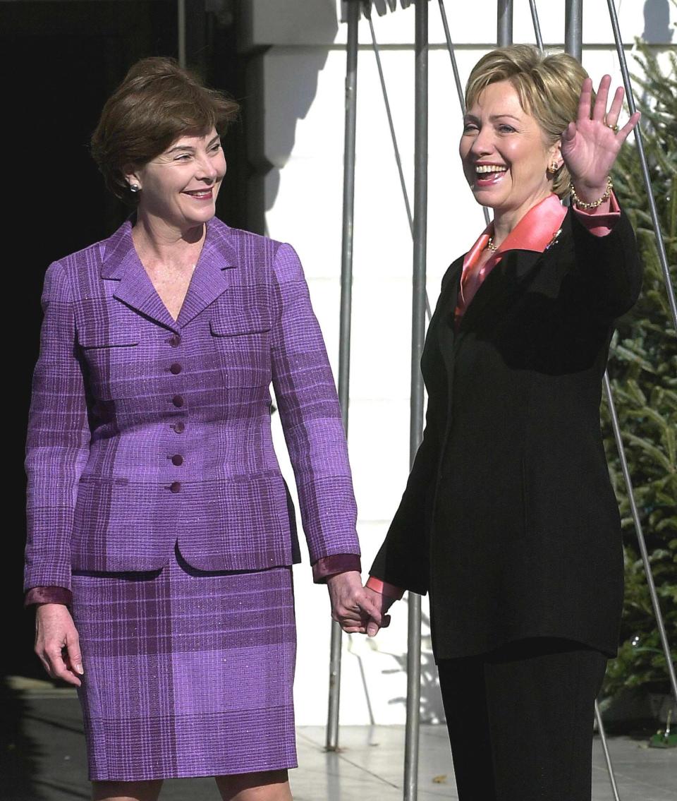 First lady Hillary Clinton waves as she greets incoming first lady Laura Bush Dec. 18, 2000 at the White House.