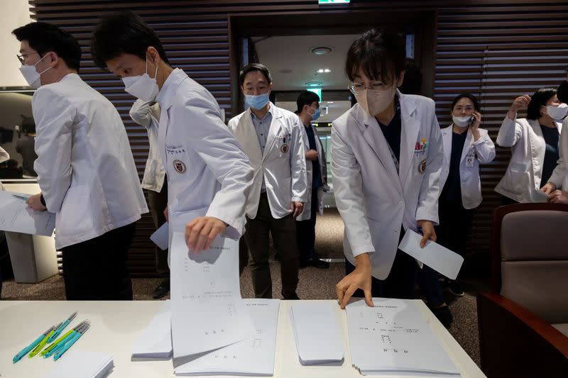 Professors at a medical school pick up resignation forms at a hospital in Seoul