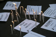 Candles are lit next to messages as students express hope and solidarity for the passengers aboard the missing Malaysian Airlines plane Thursday, March 13, 2014 in Manila, Philippines. Planes sent Thursday to check the spot where Chinese satellite images showed possible debris from the missing Malaysian jetliner found nothing, Malaysia's civil aviation chief said, deflating the latest lead in the six-day hunt. The hunt for the missing Malaysia Airlines flight 370 has been punctuated by false leads since it disappeared with 239 people aboard about an hour after leaving Kuala Lumpur for Beijing early Saturday. (AP Photo/Bullit Marquez)