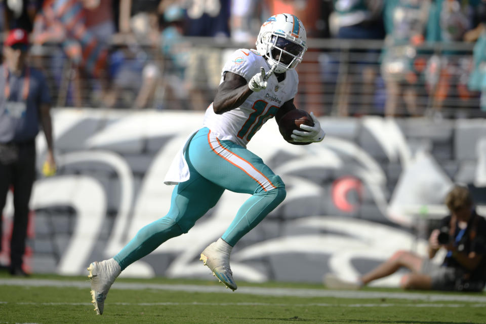 Miami Dolphins wide receiver Tyreek Hill (10) gestures as he runs for a touchdown during the second half of an NFL football game against the Baltimore Ravens, Sunday, Sept. 18, 2022, in Baltimore. (AP Photo/Nick Wass)