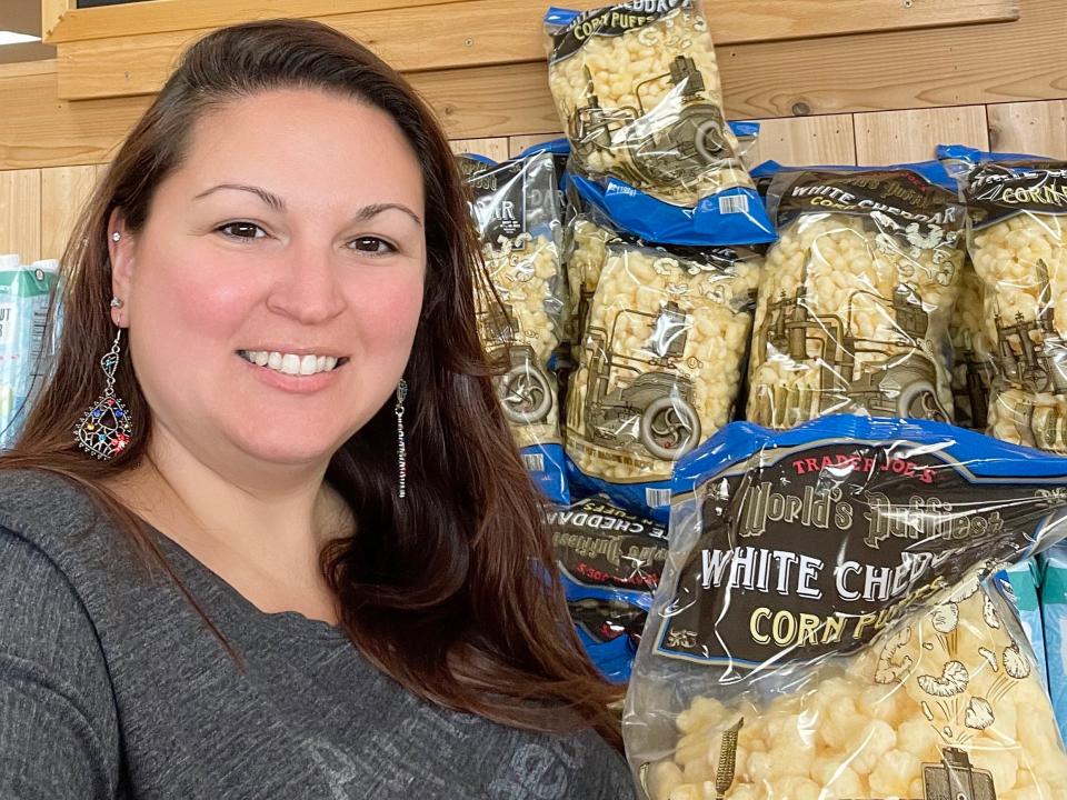 the writer posing with trader joe's white cheddar puffs