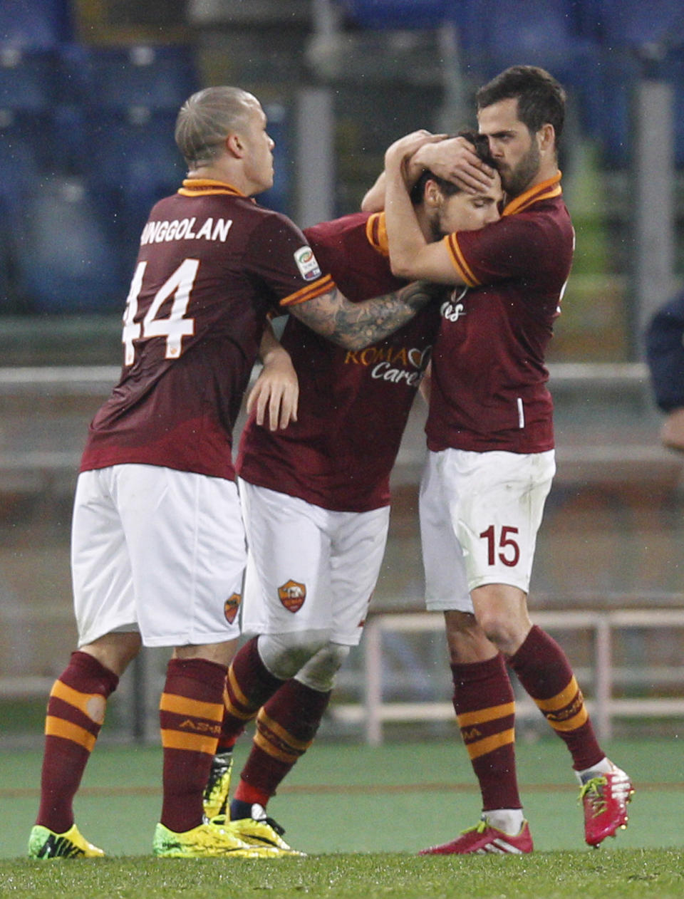 AS Roma forward Mattia Destro center, is celebrated by his teammates Radja Nainggolan of Belgium, left, and Miralem Pjanic of Bosnia-Erzegovina after he scored during a Serie A soccer match between AS Roma and Torino, at Rome's Olympic Stadium, Tuesday, March 25, 2014. (AP Photo/Andrew Medichini)