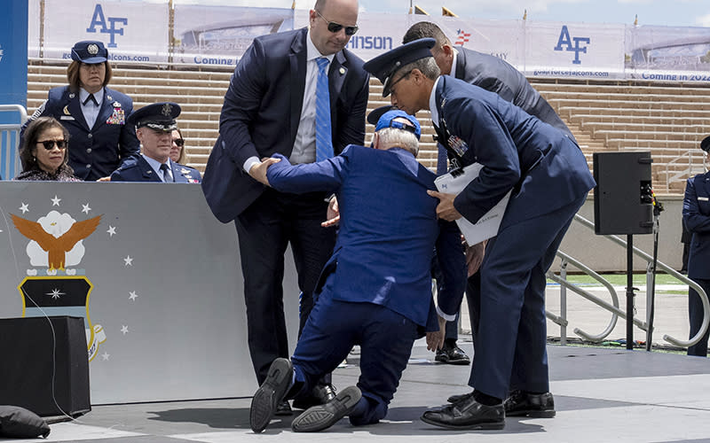 President Biden is helped to his feet after falling on stage during the 2023 U.S. Air Force Academy graduation ceremony