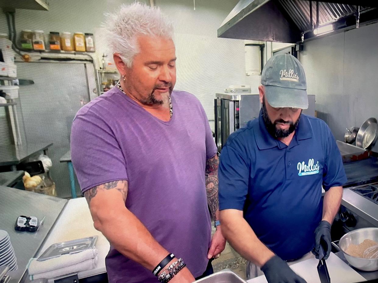 Guy Fieri alongside Millie's Restaurant and Catering owner Chris Chibbaro on "Diners, Drive-Ins and Dives."
