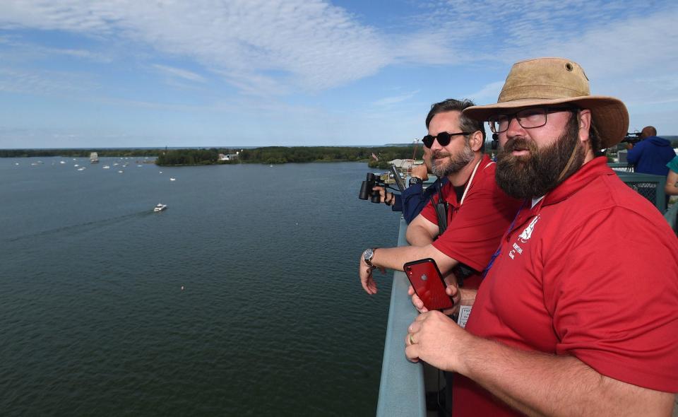 Joe Lengieza, left, director of sail operations for the Flagship Niagara League, and Billy Sabatini, executive director and fleet captain of the Flagship Niagara League monitor the 2019 Parade of Sail from the top of the Bicentennial Tower at the start of the Tall Ships Erie 2019 festival on Aug. 22, 2019.