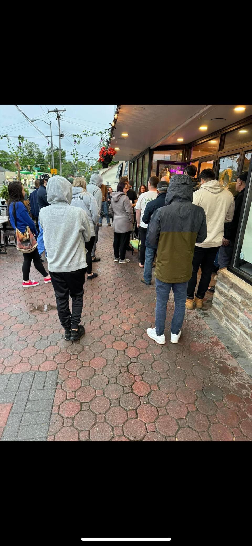 Customers are waiting in line for pizza at Cafe Crevier after influencer Dave Portnoy gave their pie a high score.