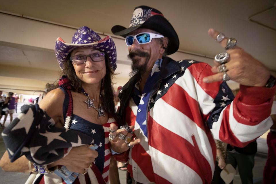 Trump supporters pose for photos before former President Donald Trump is scheduled to speak at the Palm Beach County Convention Center in West Palm Beach, Florida on October 11, 2023.