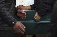 <p>A man passes the hand of a deceased woman on a stretcher in a hospital following a suicide attack in Kabul, Afghanistan, Thursday, Dec. 28, 2017. (Photo: Rahmat Gul/AP) </p>