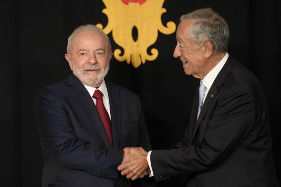 Portuguese President Marcelo Rebelo de Sousa, right, greets Brazil president-elect Luis Inacio Lula da Silva as he arrives at the Belem Presidential palace in Lisbon, Friday, Nov. 18, 2022. Lula arrived in Lisbon Friday to meet with Rebelo de Sousa and later with Prime Minister Antonio Costa. (AP Photo/Armando Franca)