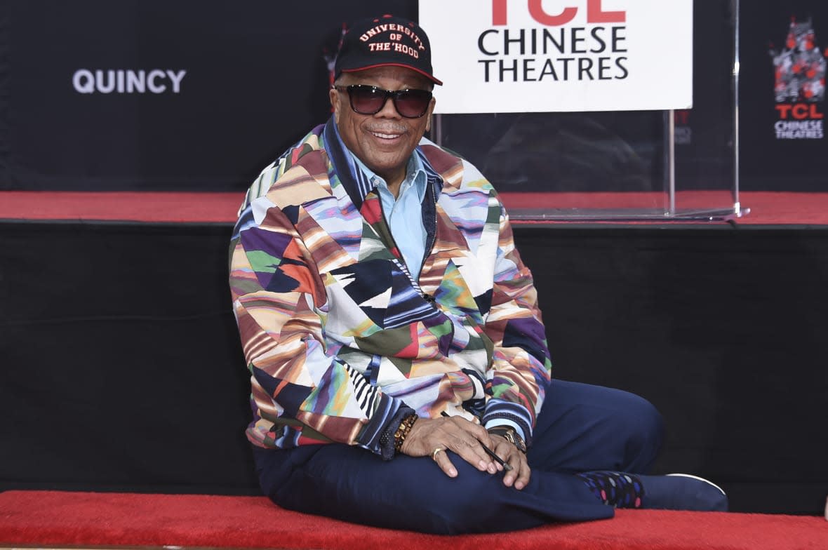 Quincy Jones poses for photos after placing his hands in wet cement during a hand and footprint ceremony honoring Jones on Nov. 27, 2018, at the TCL Chinese Theatre in Los Angeles. (Photo by Richard Shotwell/Invision/AP)