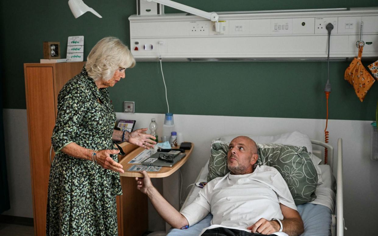 Queen Camilla speaks to cancer patient Paul Holdway on her visit to Bath