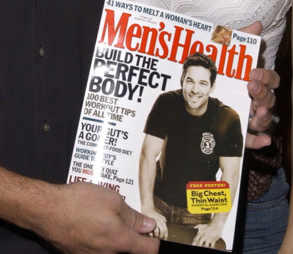 Eddie Cibrian holding a Men's Health issue with him on the cover