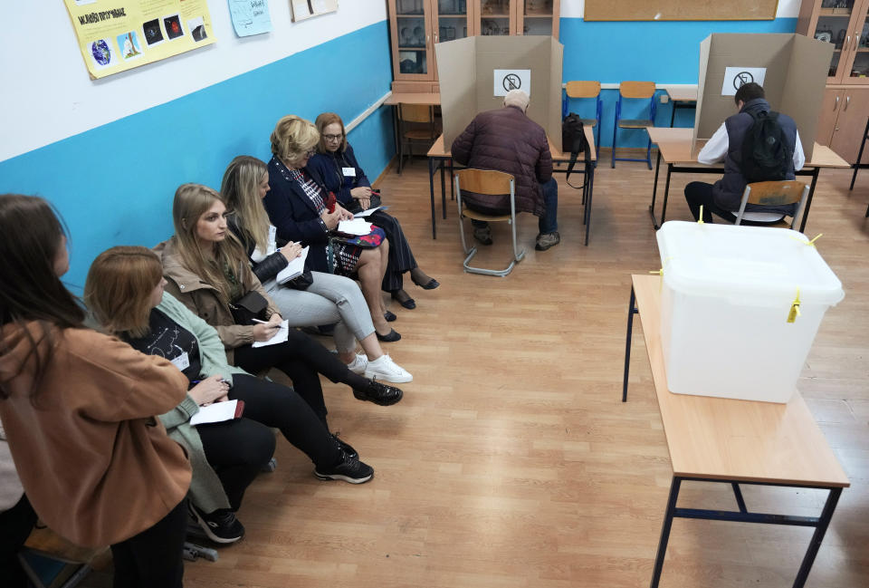 People prepare ballots for a general election at a poling station in the Bosnian town of Banja Luka, 240 kms northwest of Sarajevo, Sunday, Oct. 2, 2022. Polls opened Sunday in Bosnia for a general election that is unlikely to bring any structural change despite palpable disappointment in the small, ethnically divided Balkan country with the long-established cast of sectarian political leaders. (AP Photo/Darko Vojinovic)