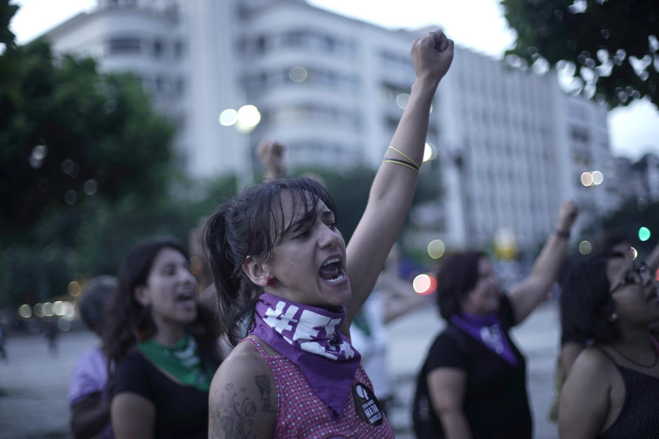 Women perform the feminist anthem "A rapist in your path," in a demonstration against gender-based violence in Rio de Janeiro, Brazil, Friday, Dec. 13, 2019. (AP Photo/Silvia Izquierdo)