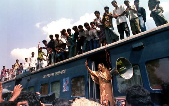 Hasina waves at followers as she begins the second phase of a train march to muster support to topple the government in September 1994.<span class="copyright">Rafiquar Rahman—Reuters</span>