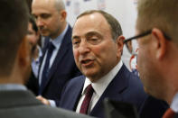 FILE - In this Dec. 12, 2019, file photo, NHL Commissioner Gary Bettman speaks with members of the media before being inducted into the U.S. Hockey Hall of Fame in Washington. The uncertainty raised by coronavirus pandemic leads to experts providing a bleak short-term assessment on the NHL's financial bottom line, with some projecting revenues being cut by almost half. What's unclear is how large the impact might be until it can be determined when fans can resume attending games and if the league is able to complete this season. (AP Photo/Patrick Semansky, File)