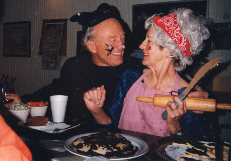 Walt Dear, with whiskers and a pink nose painted on his face, grins at his wife, Martha, adorned in a gray wig and brandishing a carving knife and rolling pin at Planter’s Coffee House on Main Street in Henderson sometime in the 1990s. As a Halloween gag, they had dressed up in a recreation of the nursery rhyme “Three Blind Mice,” with Martha in the role of the farmer’s wife chasing Walt, as a mouse, down Main Street, drawing a crowd into Planter’s at lunchtime.