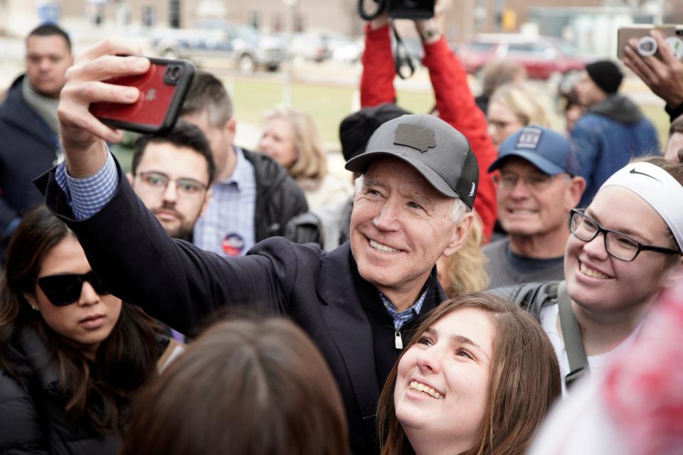 Former Vice President Joe Biden takes a selfie with supporters following a presidential campaign stop in Council Bluffs, Iowa, in 2019.
