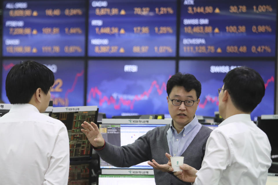 Currency traders work at the foreign exchange dealing room of the KEB Hana Bank headquarters in Seoul, South Korea, Monday, Dec. 9, 2019. Asian shares were mostly higher Monday cheered by a buying mood on Wall Street that came at the end of last week. (AP Photo/Ahn Young-joon)