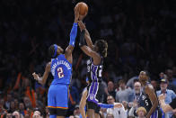 Oklahoma City Thunder guard Shai Gilgeous-Alexander (2) blocks a shot by Sacramento Kings guard Keon Ellis, middle, as Kings guard De'Aaron Fox (5) watches during the second half of an NBA basketball game Tuesday, April 9, 2024, in Oklahoma City. (AP Photo/Nate Billings)